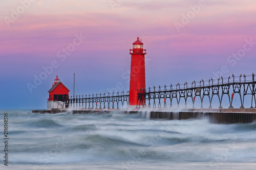 Landscape of the Grand Haven, Michigan Lighthouse at dawn with splashing waves, Lake Michigan, USA