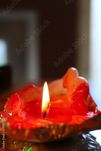 A burning candle in the form of a figurine.