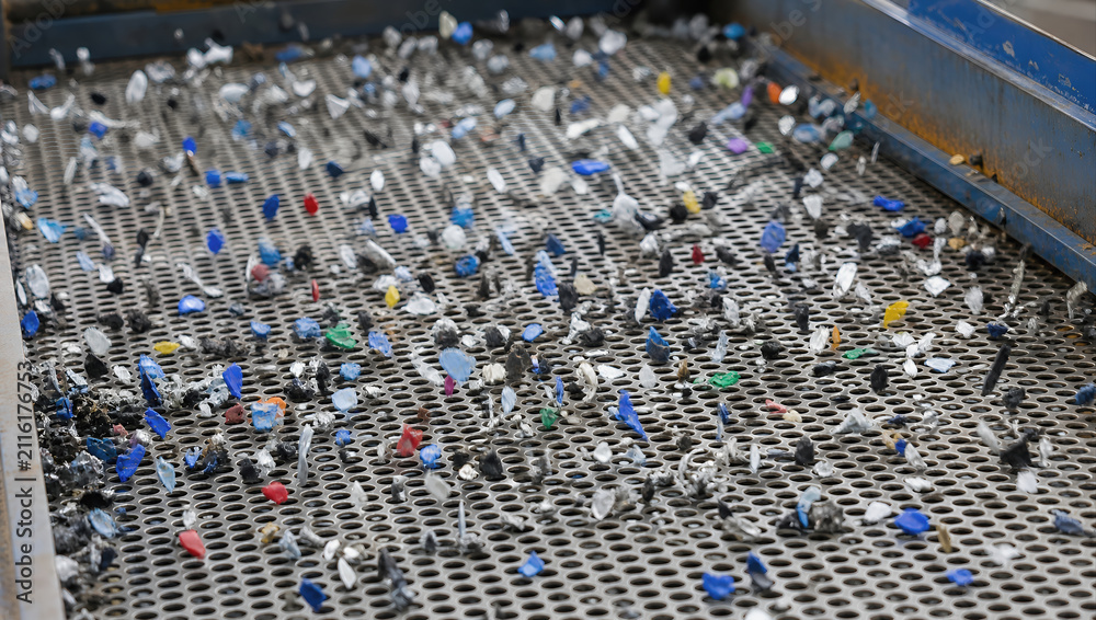 Fototapeta premium Color plastic fragment recycling plant waste sorting metal screen industrial process environment sustainability material recovery small piece