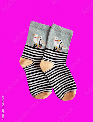 A pair of soft children's socks with a vibrant print. Cozy and warm knitted apparel for toddlers, isolated close-up shot. Concept of comfort, care, and kids' fashion.