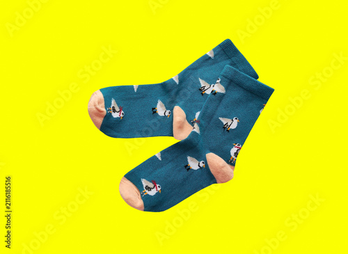 A pair of soft children's socks with a vibrant print. Cozy and warm knitted apparel for toddlers, isolated close-up shot. Concept of comfort, care, and kids' fashion.