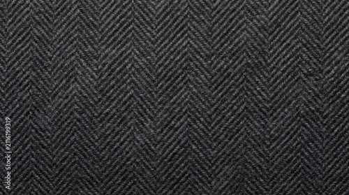 Dark gray herringbone fabric texture background