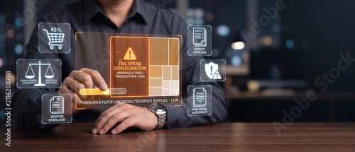 Business procurement manager analyzing tail spend consolidation data on a futuristic digital interface in a modern office