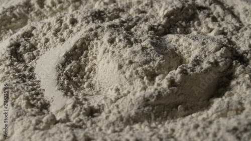White wheat flour texture abstract macro background, rotates. Close up of organic white flour powder heap with heaps and shadows creating fine culinary texture backdrop