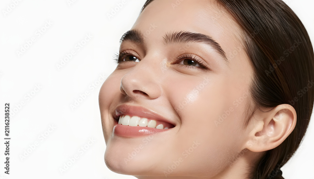 Obraz premium Smiling Young Beauty Woman with Glowing Healthy Skin, Natural Makeup and Radiant Face Portrait on White Studio Background