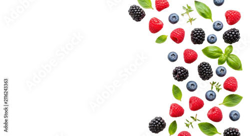Vibrant flat lay of fresh red raspberries, dark blackberries, blue blueberries, and green mint leaves on a bright white background with copy space, concept of healthy natural goodness