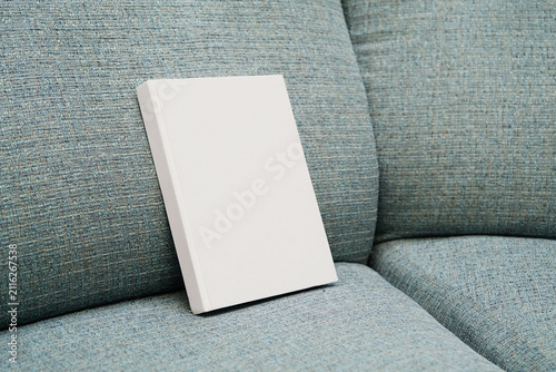 empty book mockup on soft chair indoors