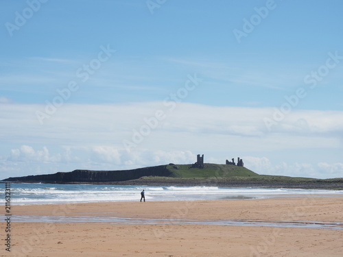 Принти на полотні Lone figure on beach with castle