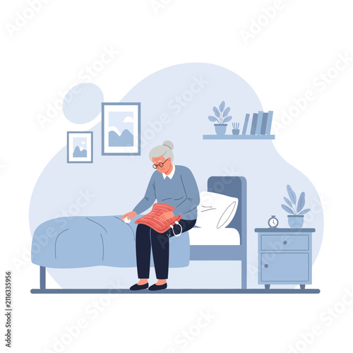 Elderly Woman Sitting On Bed Reading Book With Plants Around Her