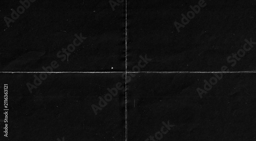 фотографія Dark black folded paper texture background with crease lines