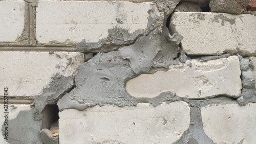 Patched Brick Corner Sloppy concrete repair work over deep structural damage on a white block wall for amateur renovation blogs construction fails and urban decay imagery