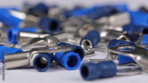 Metal tips with a plastic base for mounting on stranded copper wires. Close-up. Soft focus. Macro.
