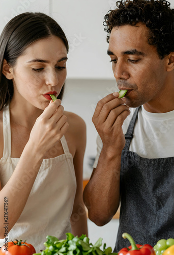 Diverse couple in aprons ta...