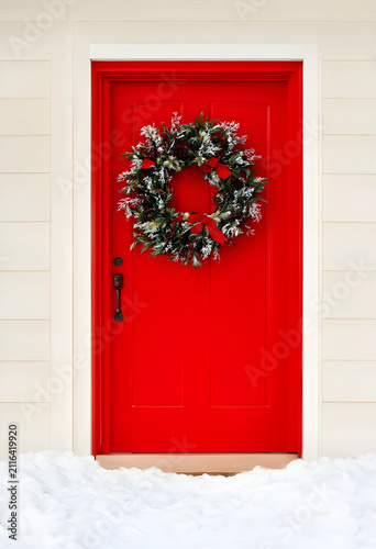 Red front door with a festi...