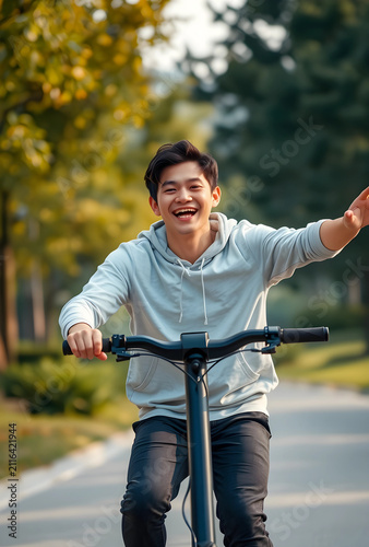 Happy young asian man ridin...