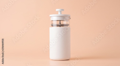 A sleek white travel French press with a glass top and filter mechanism, set against a warm peach background for a clean aesthetic.