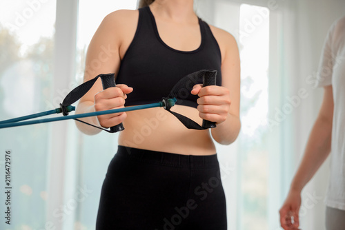 A patient using fitness therapy equipment in the clinic