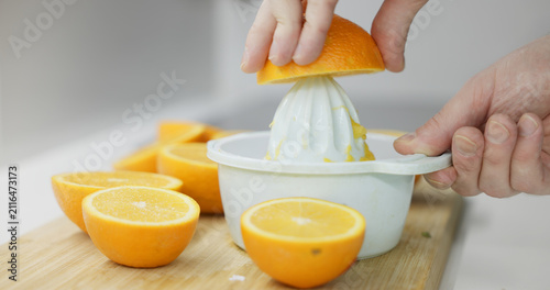 Hands extracting fresh orange juice for a healthy beverage
