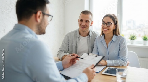 In an office, a financial consultant is explaining a new project investment to a young couple