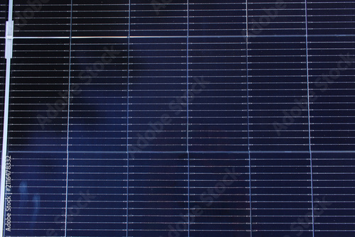 solar panel surface featuring deep blue photovoltaic cells and thin grid lines, representing renewable energy and sustainability.