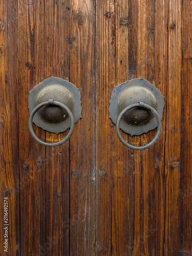 Traditional chinese door knockers on old wooden door, cultural heritage and architecture