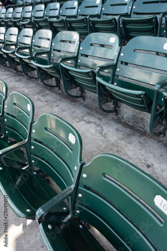 High-resolution photograph of empty seating at a professional baseball stadium with the baseball field visible in the background. 