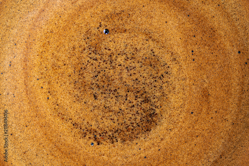 Freshly brewed espresso crema surface with golden frothy micro bubbles