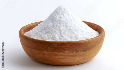 Heap of white baking soda or powder in a wooden bowl isolated on white background