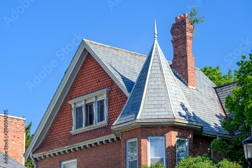 Victorian style rooftop and brick wall in house, Port Hope, Canada