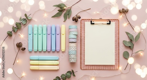 Pastel stationery set with clipboard and eucalyptus leaves.