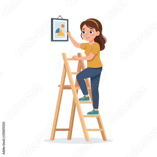 Woman climbing ladder to hang a picture indoors with a smile  