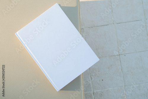 empty book mockup on lounge chair, hard light