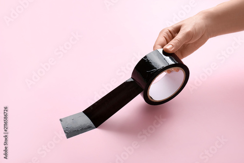 Hand holding a roll of blac...