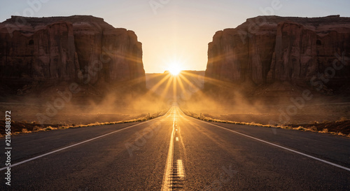 Desert Highway Leading to Sandstone Buttes in Monument Valley Landscape
