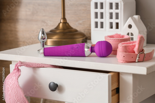 Sex toys on table in bedroo...