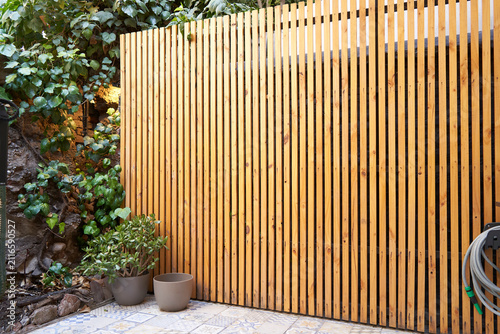 Modern vertical wooden fence in minimalist outdoor patio