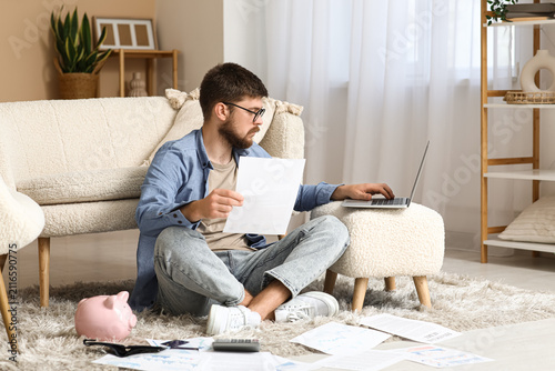 Young man in debt with pape...