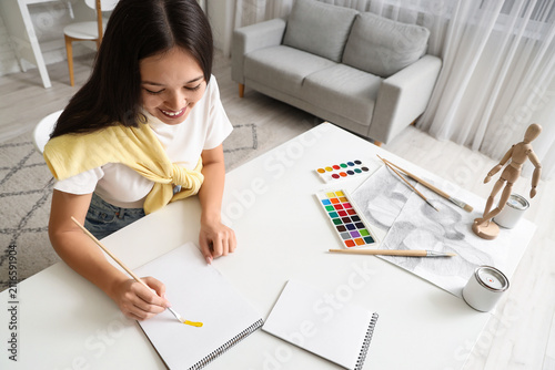 Female Asian artist drawing...