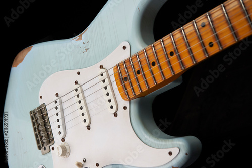 Vintage blue electric guitar isolated on black background