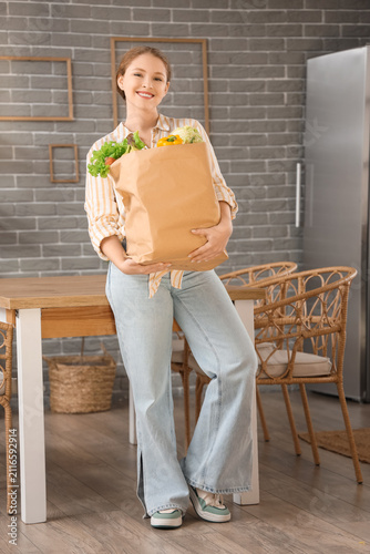 Young woman with paper bag ...