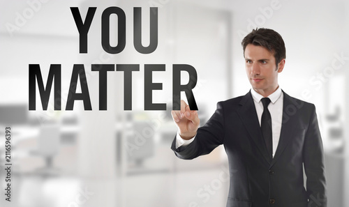 Professional businessman in a dark suit points at the words 