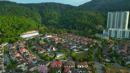 Row houses esidential area in Ferringhi hills. Smooth aerial view drone
