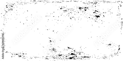 A rectangle with rough, textured edges, resembling a faded stamp or a distressed imprint. The surface is a bright white, lightly speckled with dark, granular imperfections and smudges.