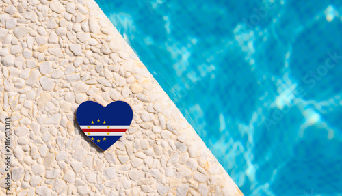 Cape Verde flag in the shape of a heart near the pool in the hotel. Holiday concept in Cape Verde