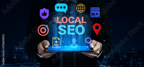 Obraz na plátně Vibrant image showcasing hands holding a tablet displaying local SEO elements, emphasizing digital marketing strategies for urban small businesses