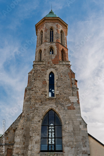 Fotografía Medieval stone tower of the Mary Magdalene Church rising against the sky above B
