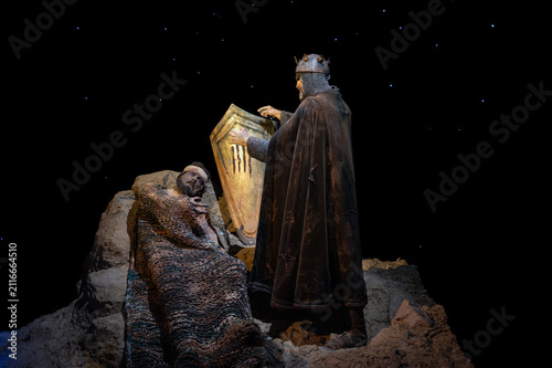 Medieval diorama depicting the legend of Wilfred the Hairy drawing four red bars with blood on a golden shield.