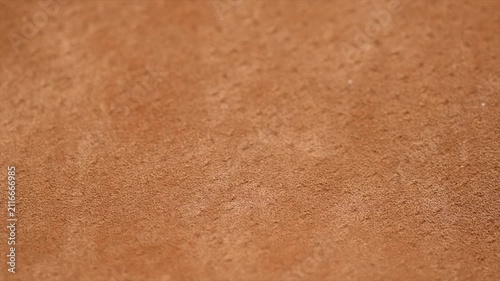 Suede texture background close up. Brown suede leather surface backdrop, genuine leather, top view. Suede of animal skin. Texture for design. Rotating background.