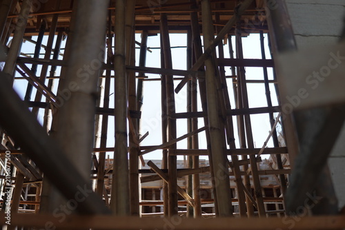 Фотография Traditional bamboo scaffolding framework used as temporary support in a building construction site
