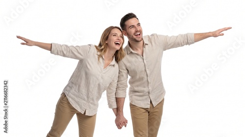 A joyful couple holding hands, with arms outstretched in a pose resembling flight, looking upwards with happy expressions, on a white background